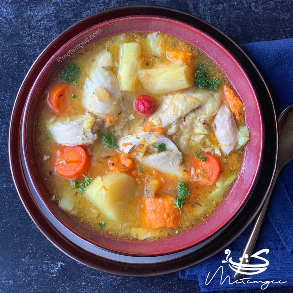 overhead view of chicken and root vegetable soup in a bowl