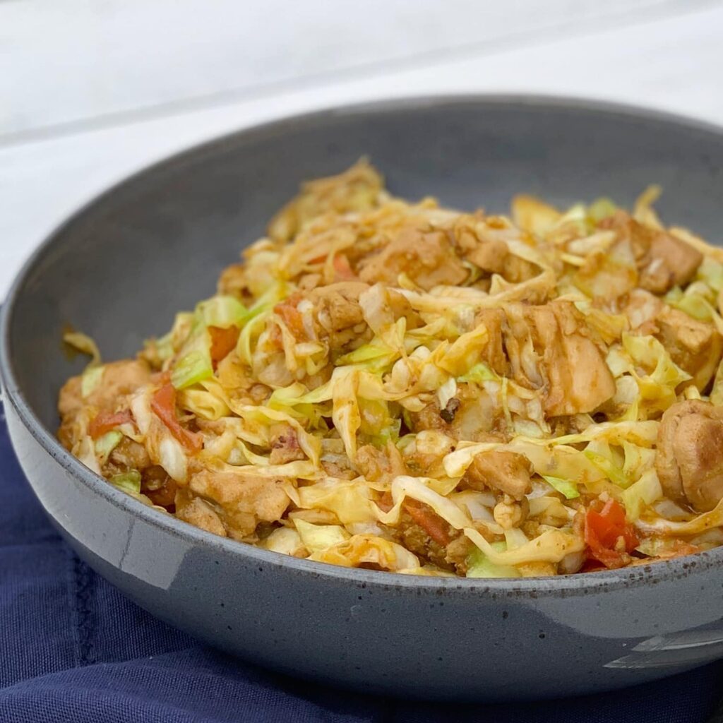 close up view of chicken and cabbage in a skillet