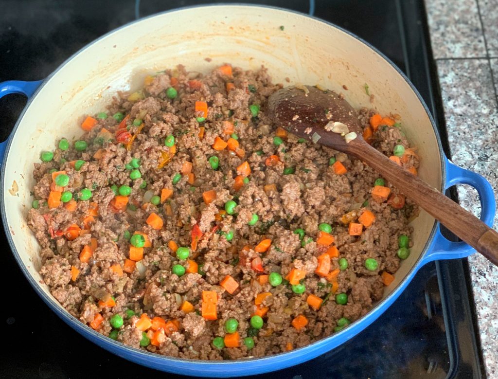 close up view of ground beef filling for shepherd's pie  cooking in a skillet 