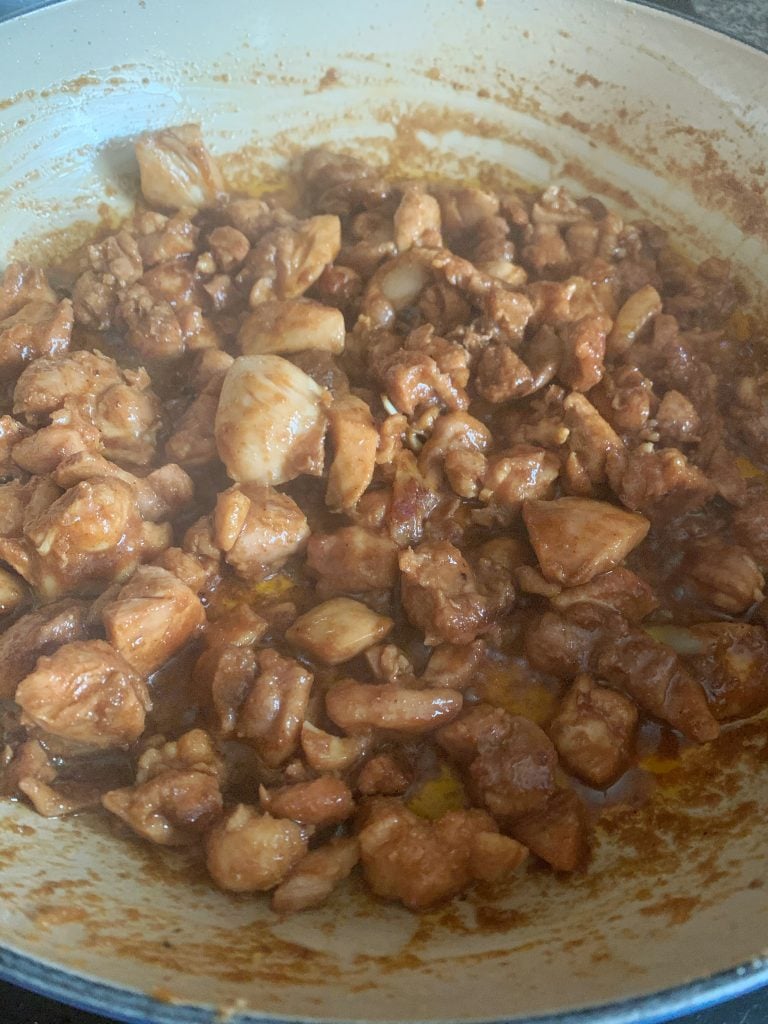 marinated chicken sautéing in a pot