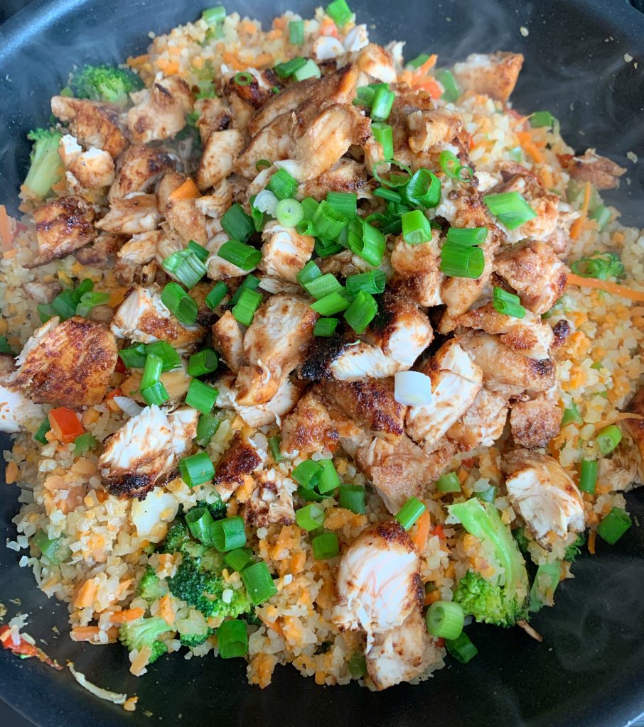 chicken added to wok for veggie fried rice
