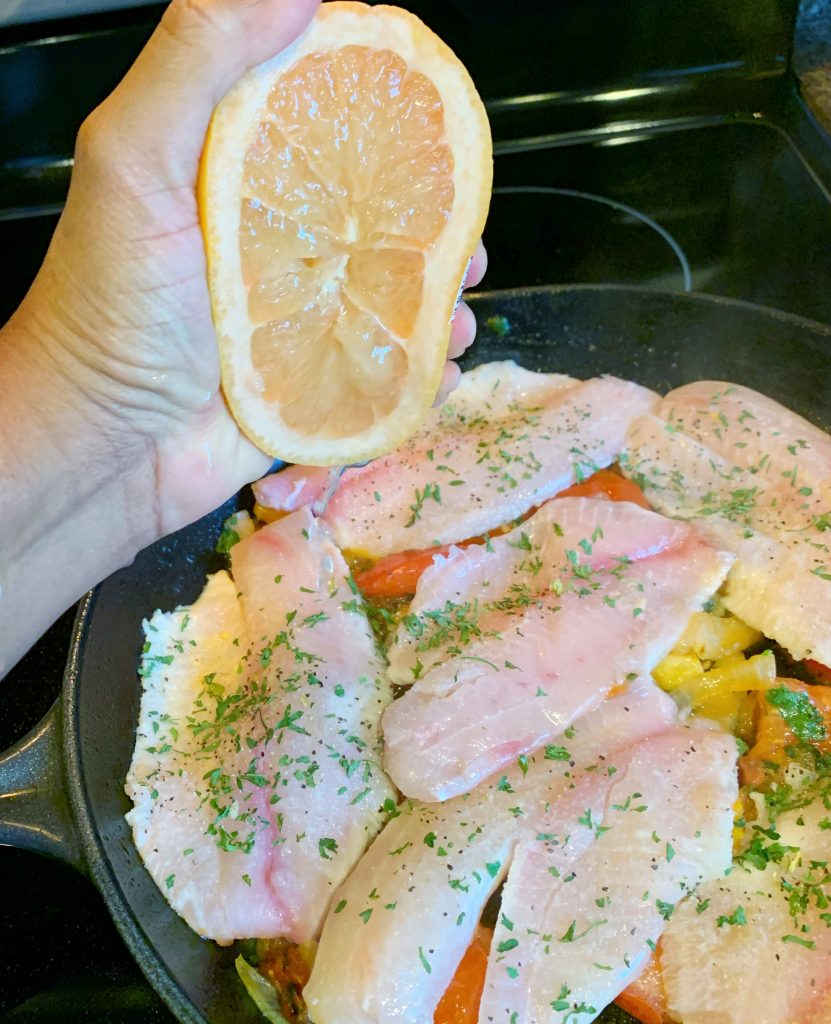 squeezing grapefruit over steamed fish