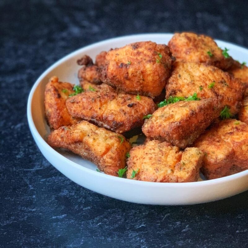 Salmon nuggets on a white plate