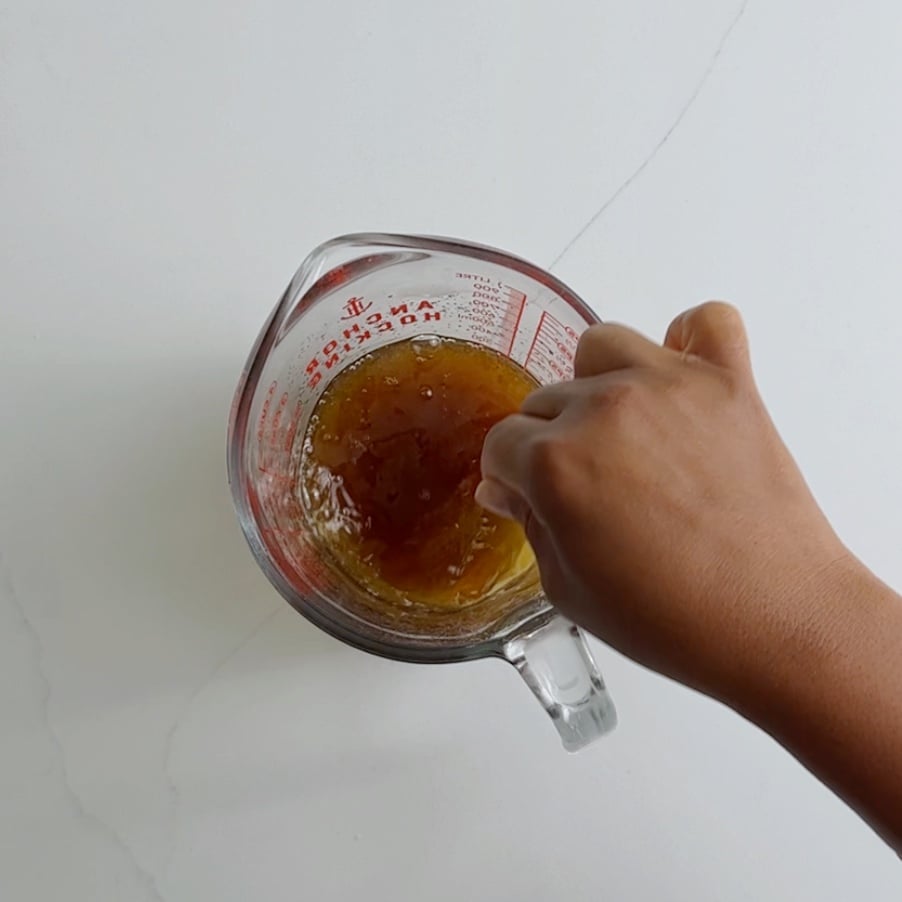 combine brown sugar and warm water in a measuring cup