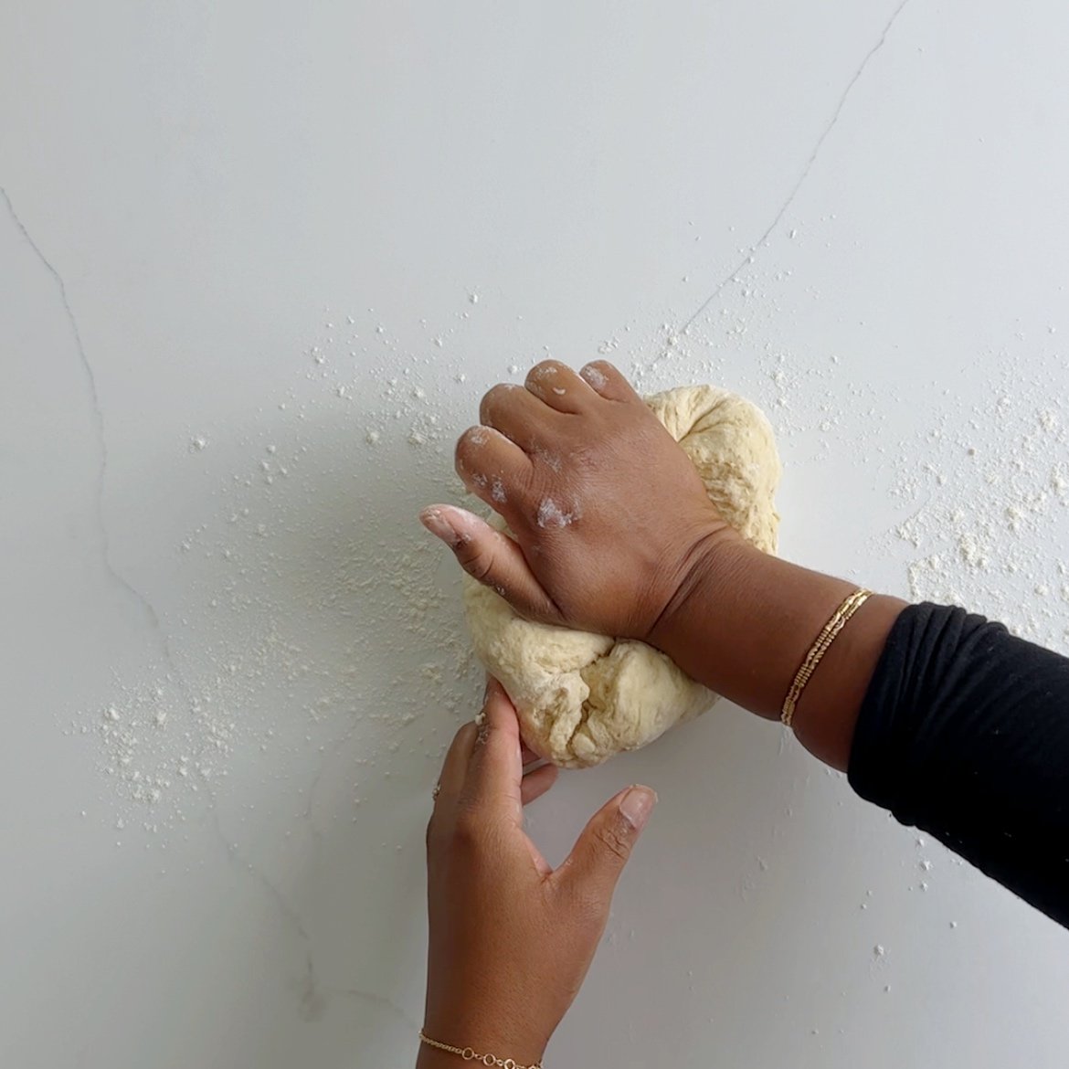 using hands to knead dough