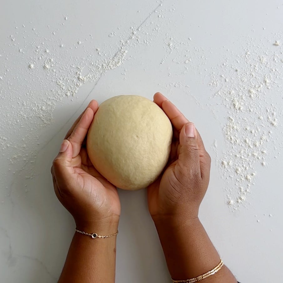 a smooth dough ball held between two hands