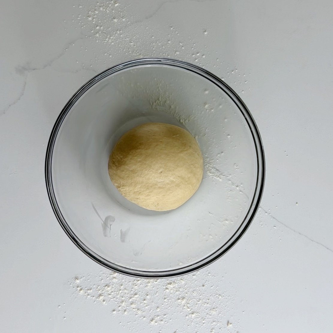 smooth dough ball in a greased bowl