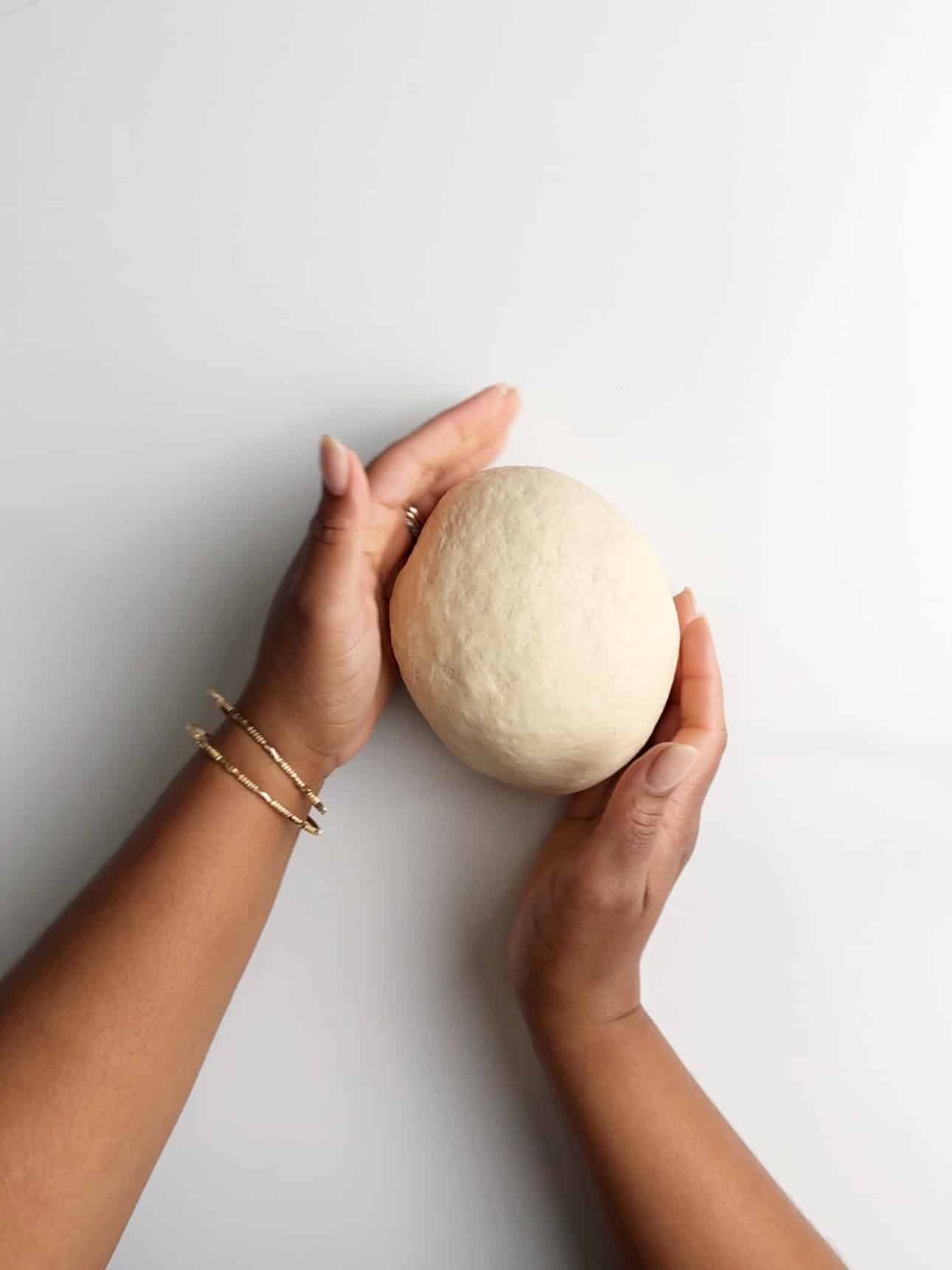 Shaping dough into a dough ball.