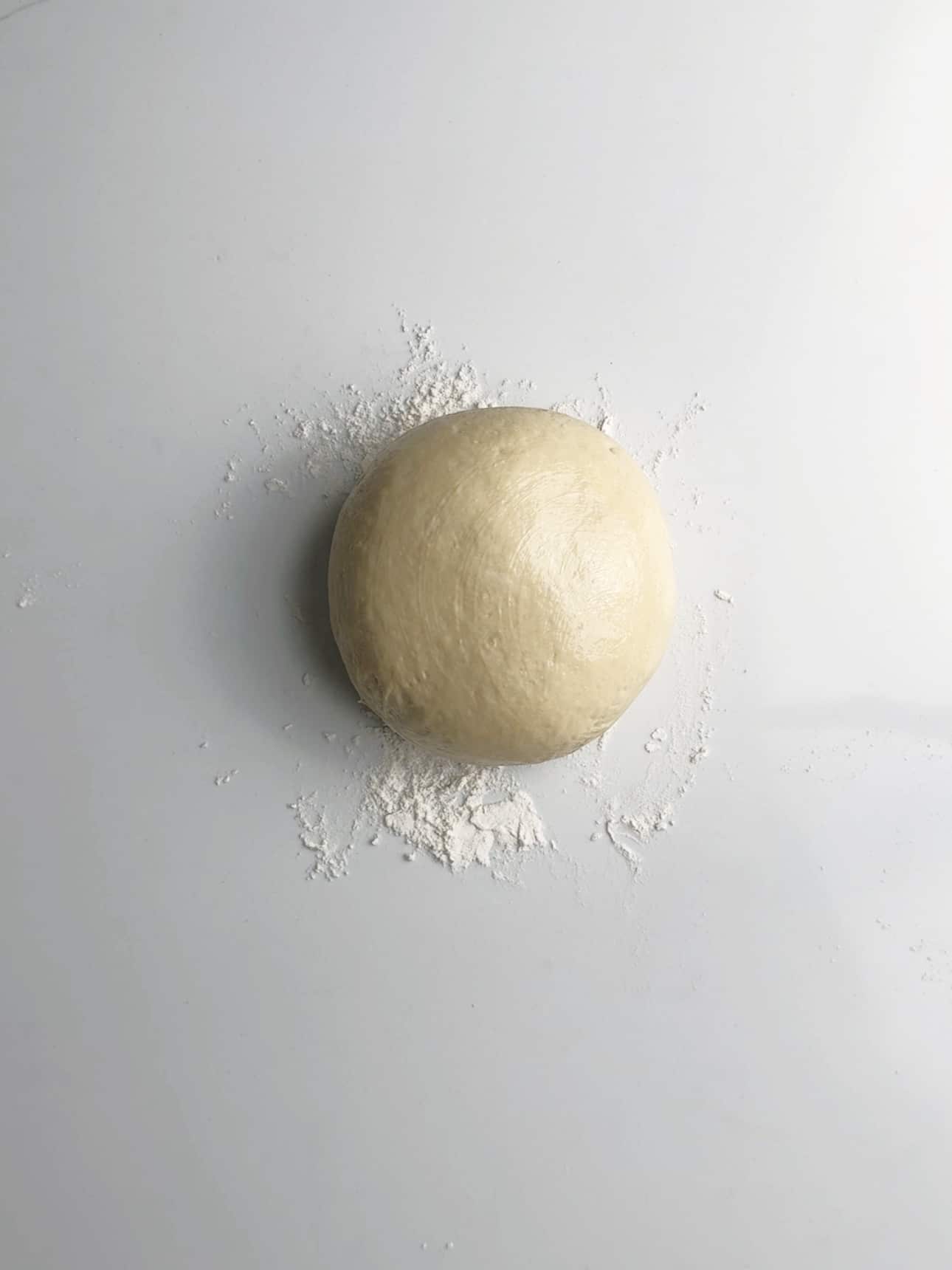Pot bake dough resting on a floured surface.