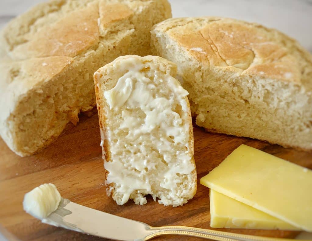 close up view of buttered pot bread with a couple slices of cheese
