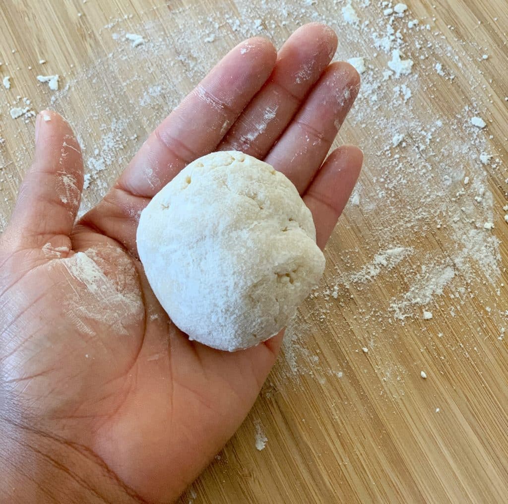 an open palm with a ball of dough