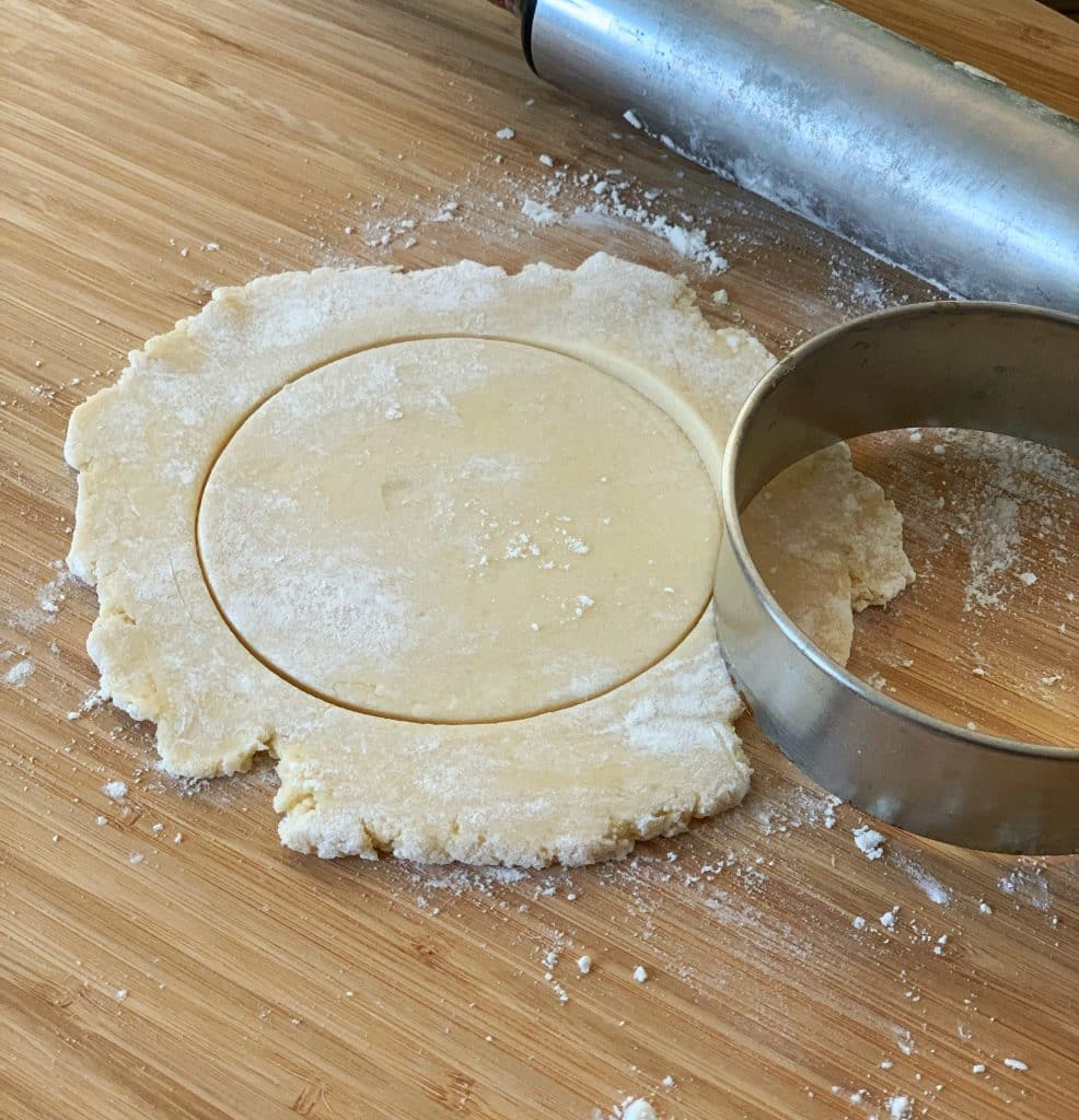 rolled out dough with a stencil showing a circular shape