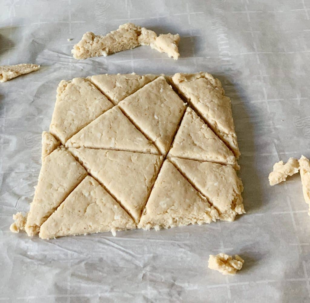 cutting out dough on parchment paper