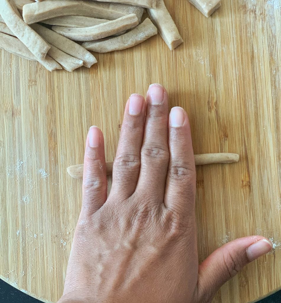 a hand rolling crispy mithai