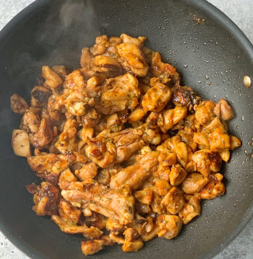 seasoned boneless chicken thighs in a wok