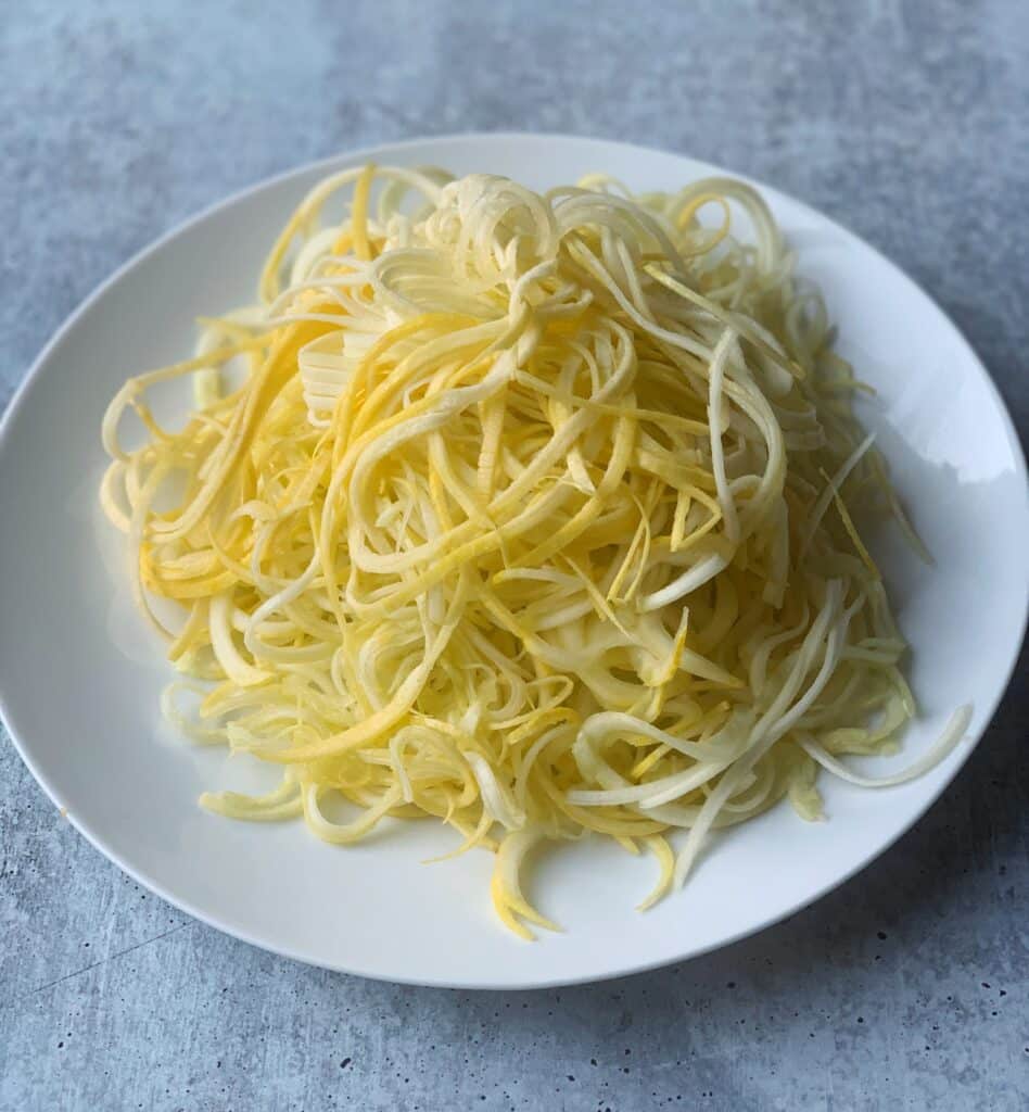 yellow squash noodles on a plate