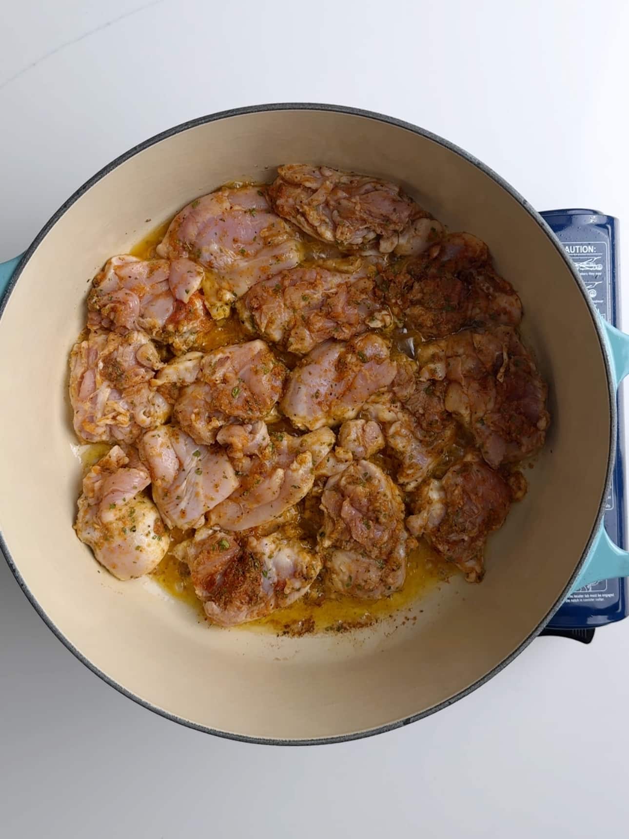 Searing Chicken in a pan to make Caribbean Chicken stew