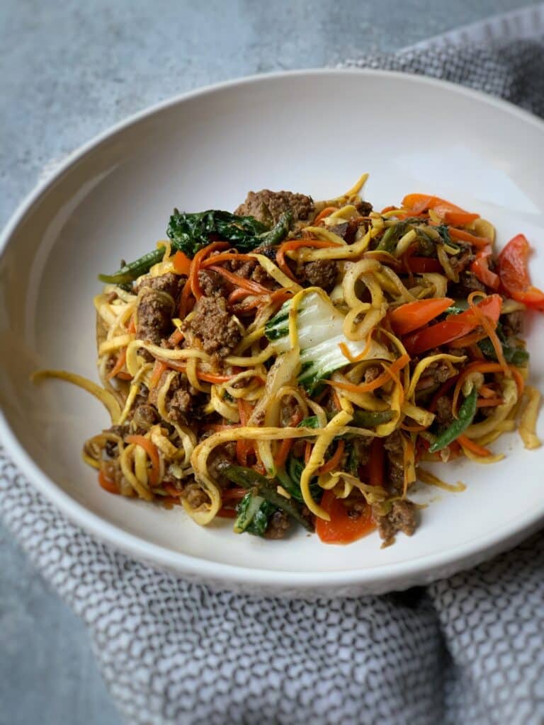 plated beef chow mein with yellow squash noodles