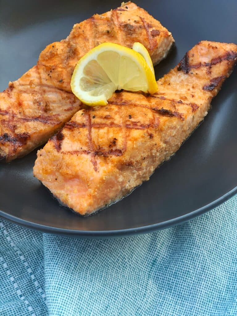 two plated grilled salmon fillets