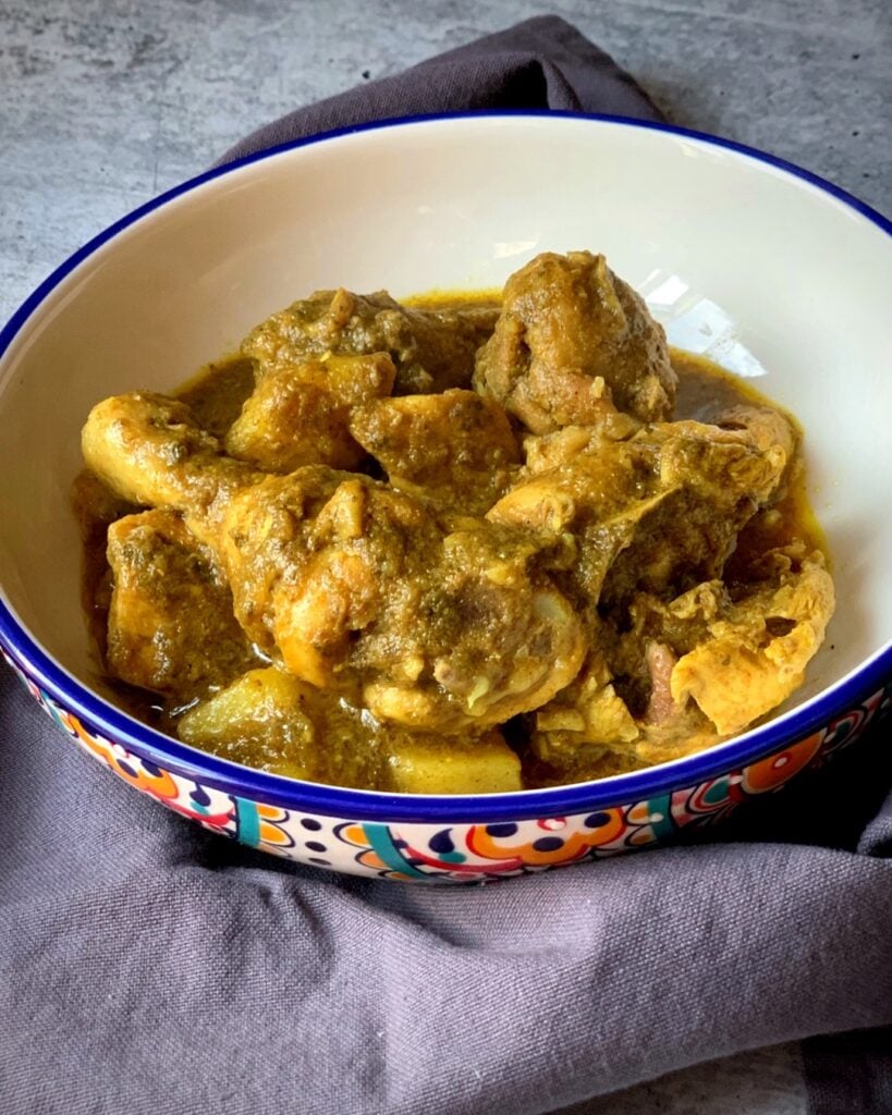 a bowl of chicken curry and potatoes