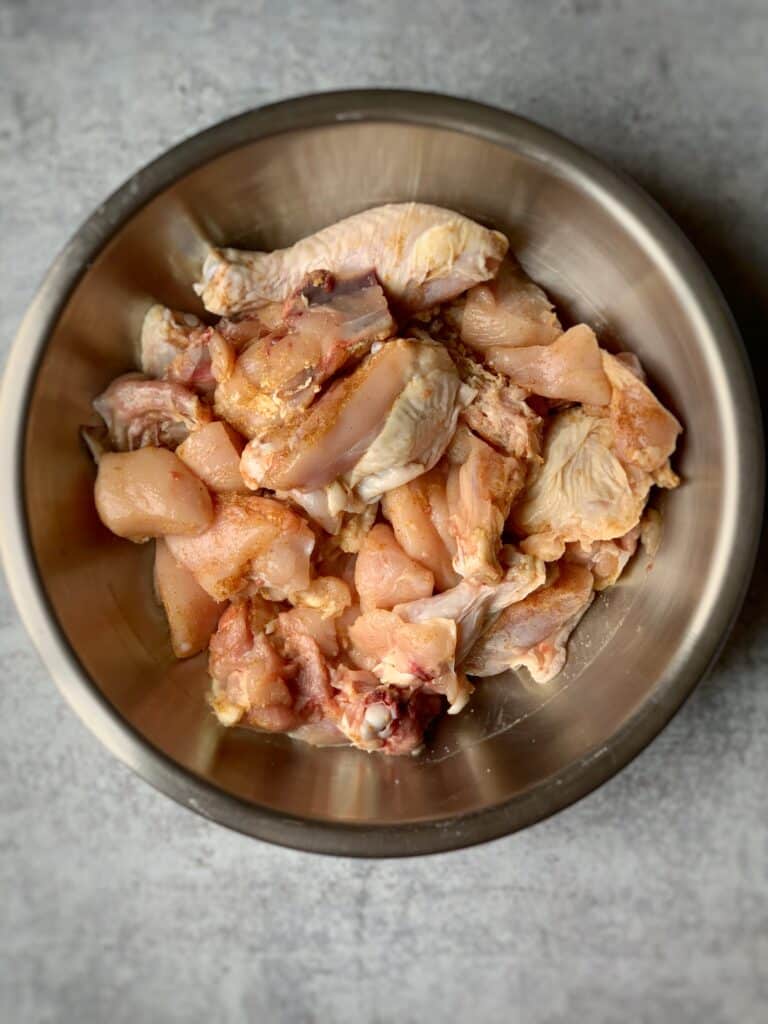 overhead view of a bowl of raw chicken