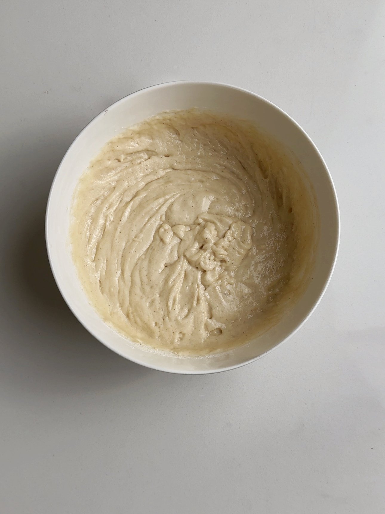 Chota batter in white bowl resting on a white surface, 