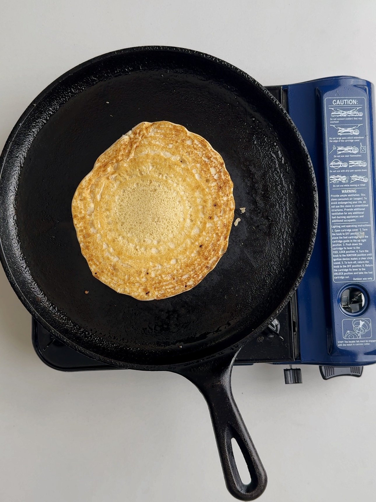 Cooked chota on a Tawa flipped over to show the brown side.