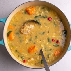 Pot of cow heel soup with a ladle in the pot.
