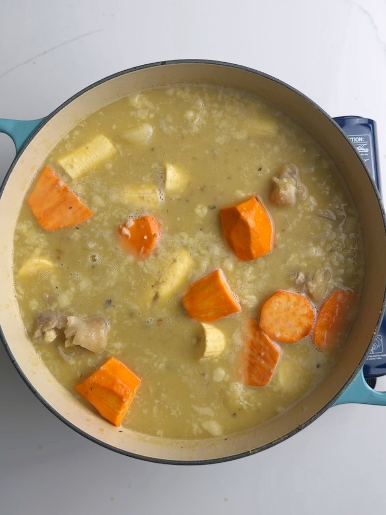 Adding root vegetables to the cooked cow heel for cow heel soup