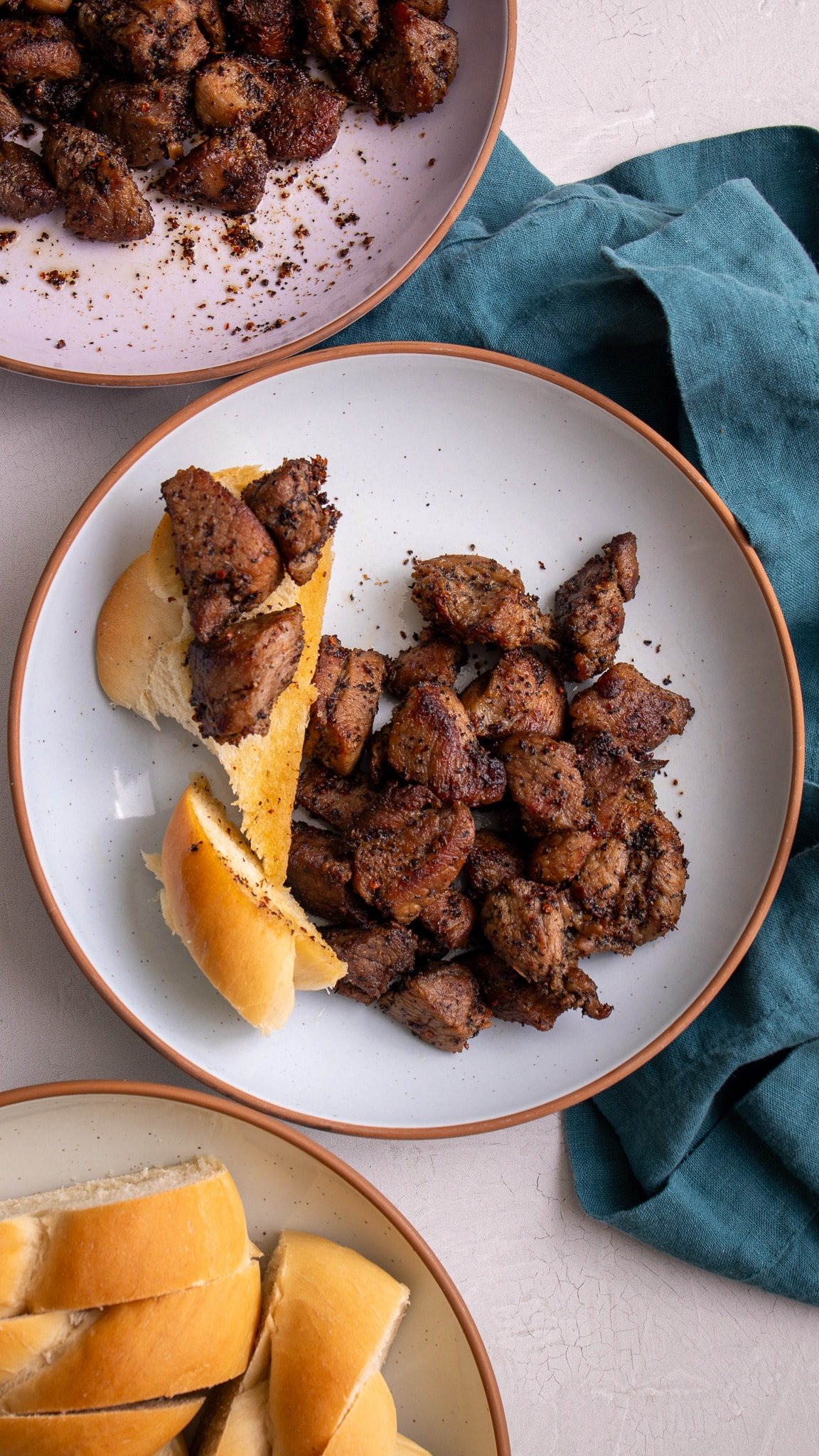 platted garlic pork with slices of bread