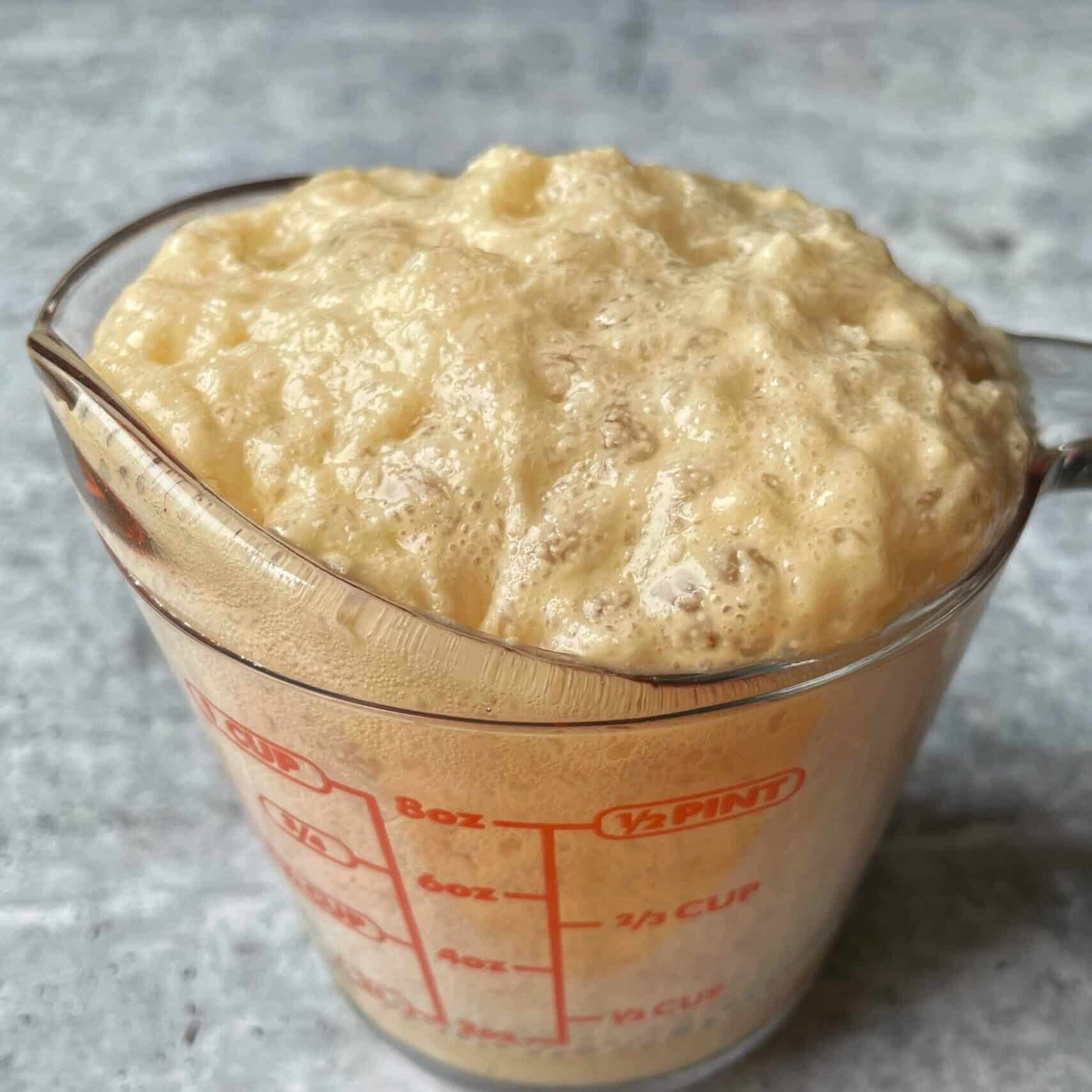 Yeast bloomed to a frothy head and over flowing the top of the measuring cup