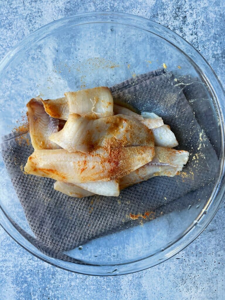 seasoned fish filets in a bowl
