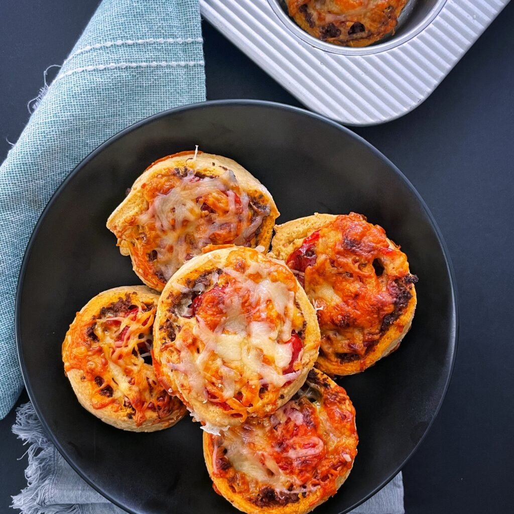 5 gluten free pinwheels stacked on each other in a black plate