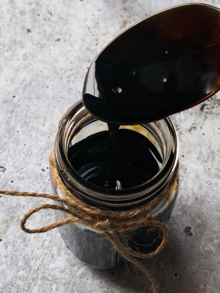 a mason jar full of thick but still loose Caribbean Burnt Sugar/browning