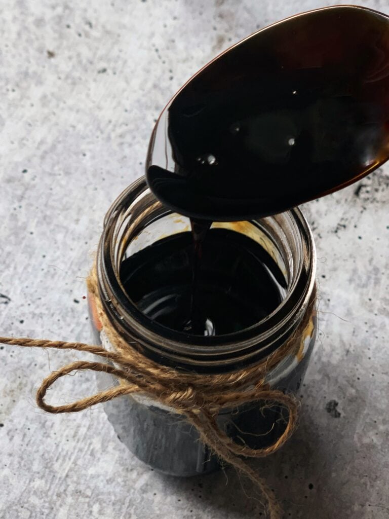 a spoon hovering over a jar of browning 