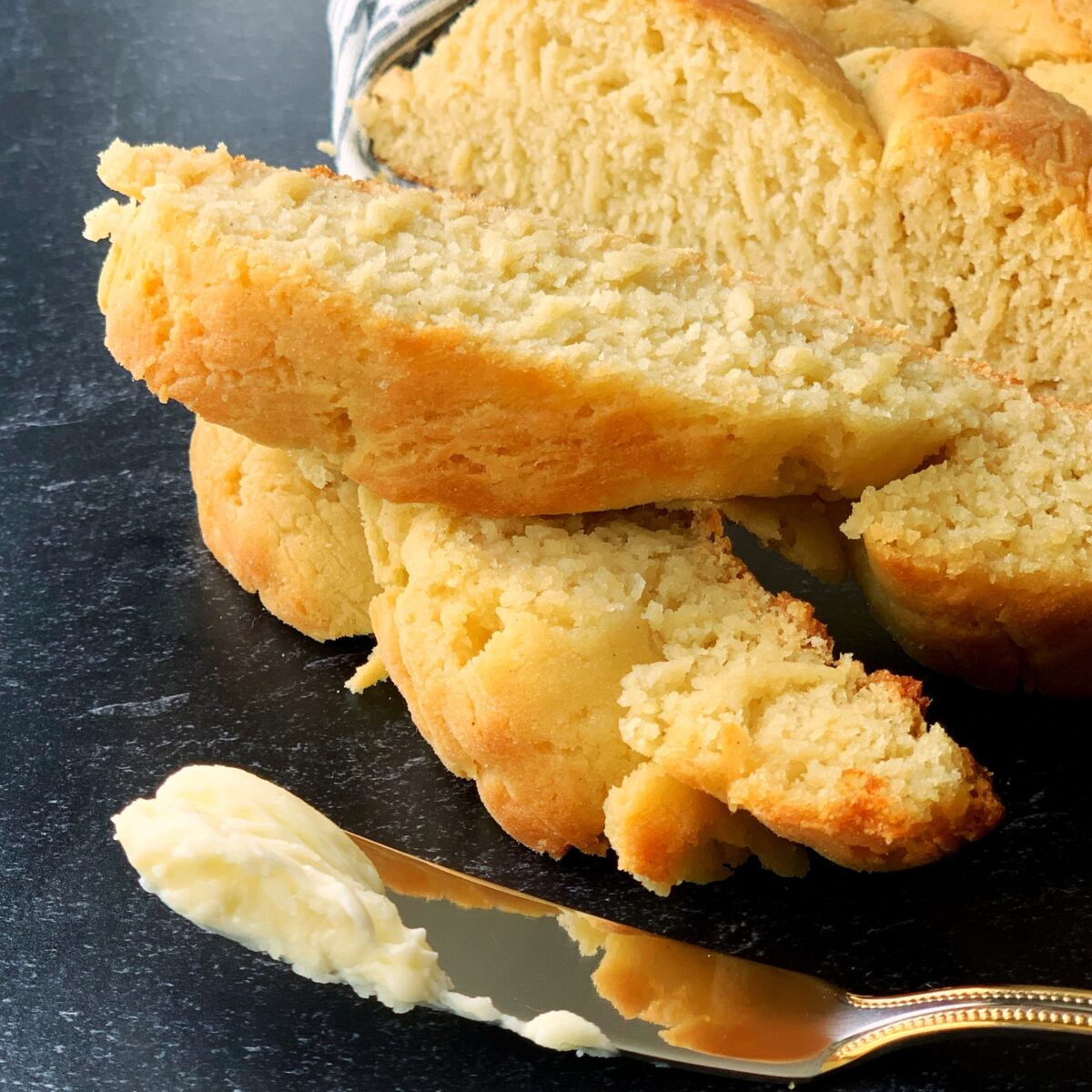 Slices of gluten free plait bread and a butter knife with butter