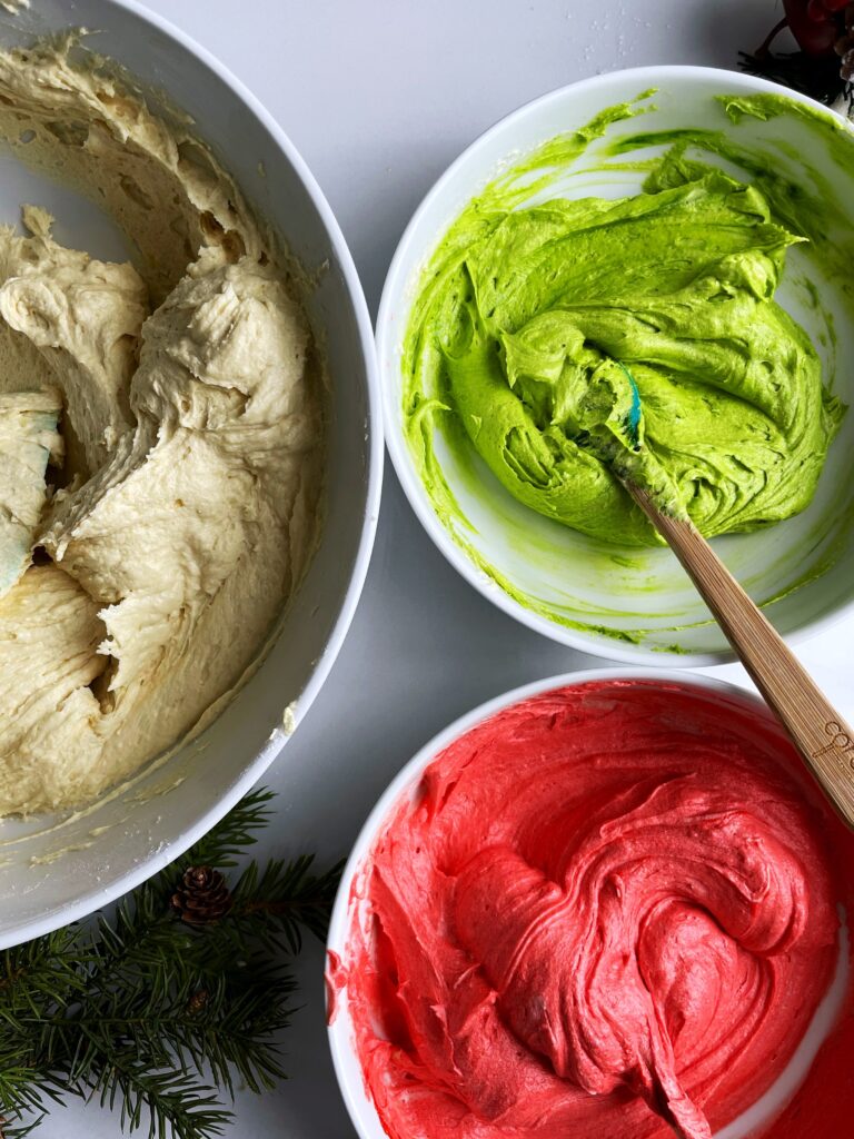 colorful sponge cake batter in three separate bowls