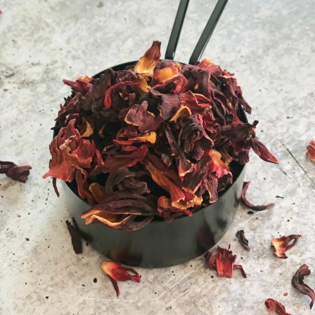 Dried sorrel blossoms in a measuring cup