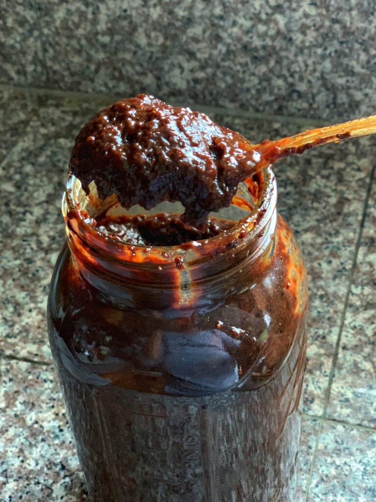 soaked fruit formed into a thick paste for black cake, set in a mason jar
