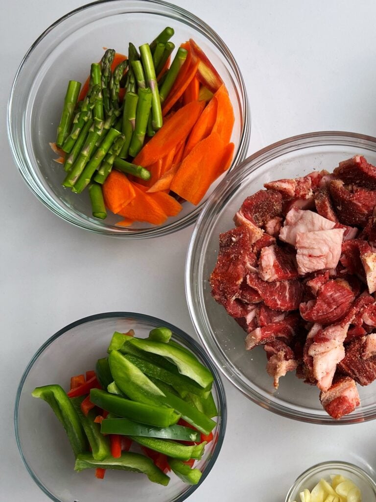 Veggies and beef in glass bowls