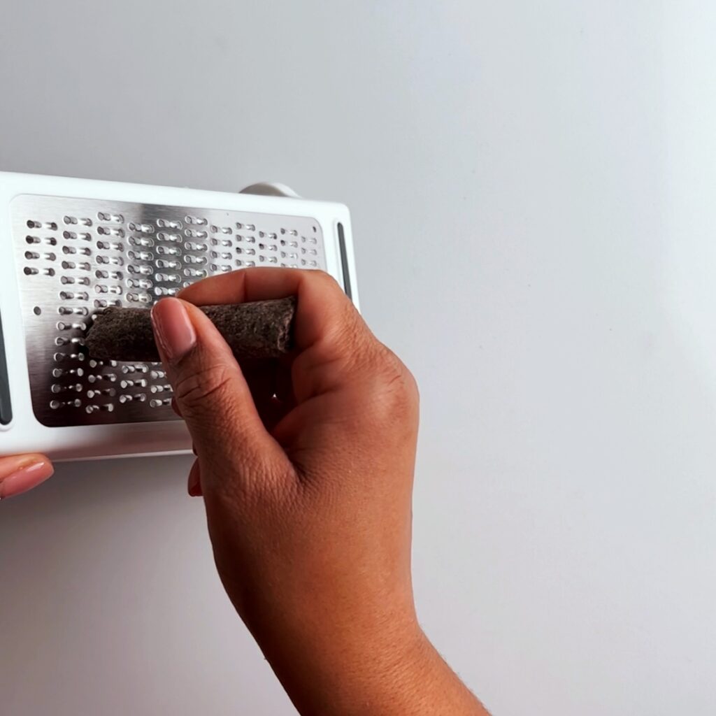 grating cocoa sticks with a box grater