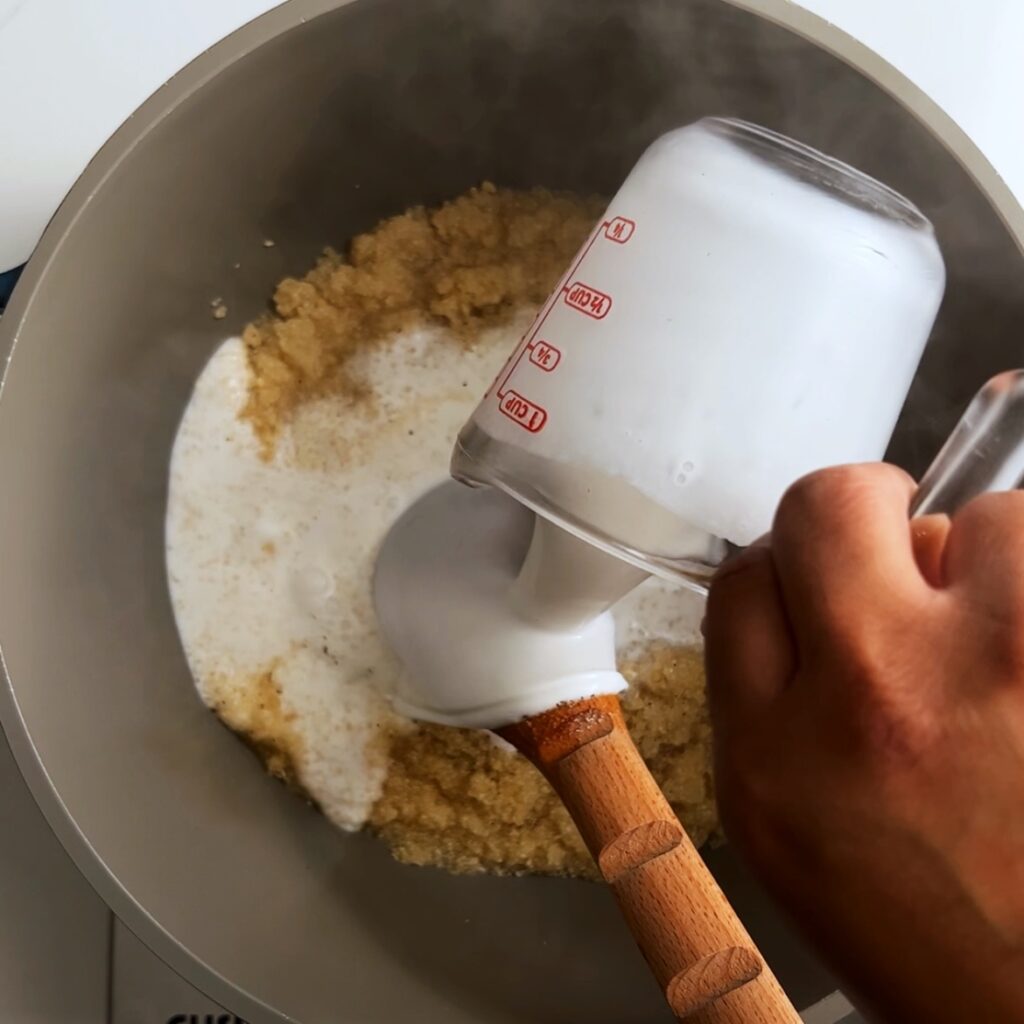 Adding coconut milk to farine in a pot