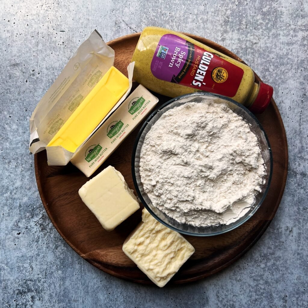 Flour, butter, cheese and spicy brown mustard on a brown plate