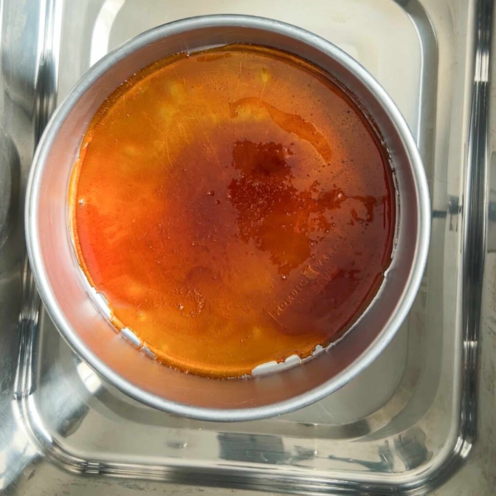 caramel in a cake pan in a baking dish
