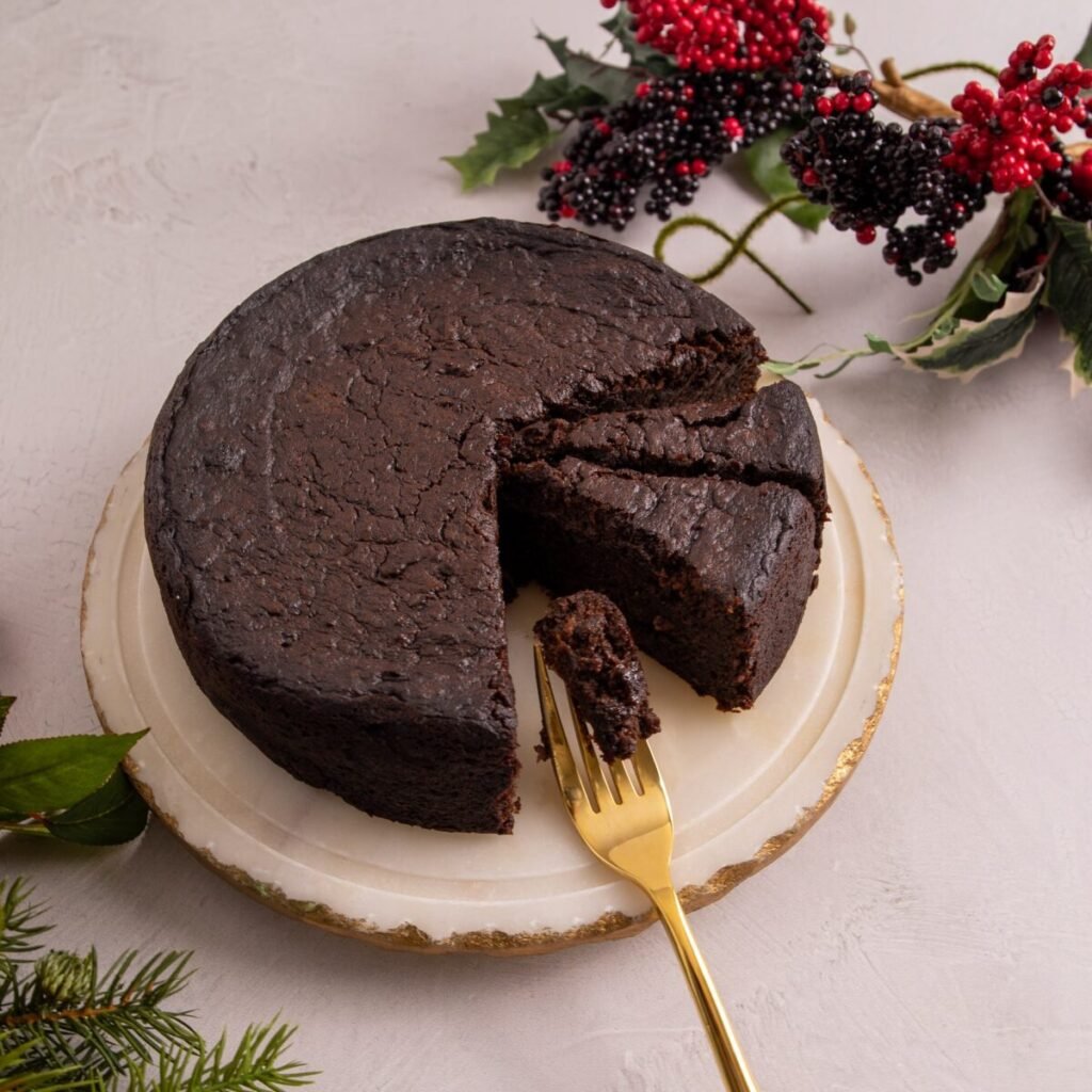 Non-alcoholic Guyanese Black Cake with a slice cut out