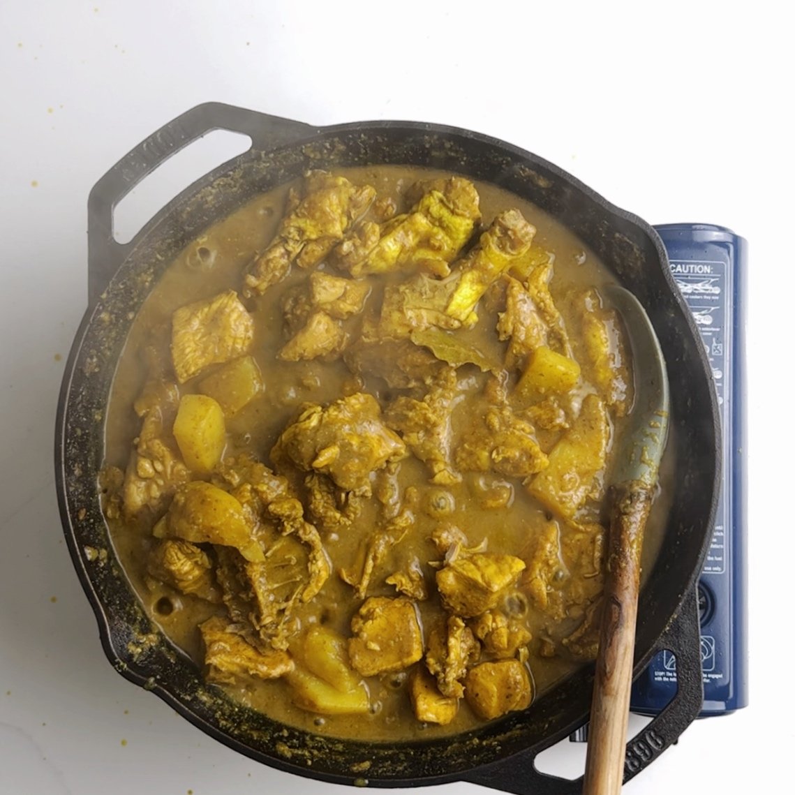 chicken curry simmering in a pot