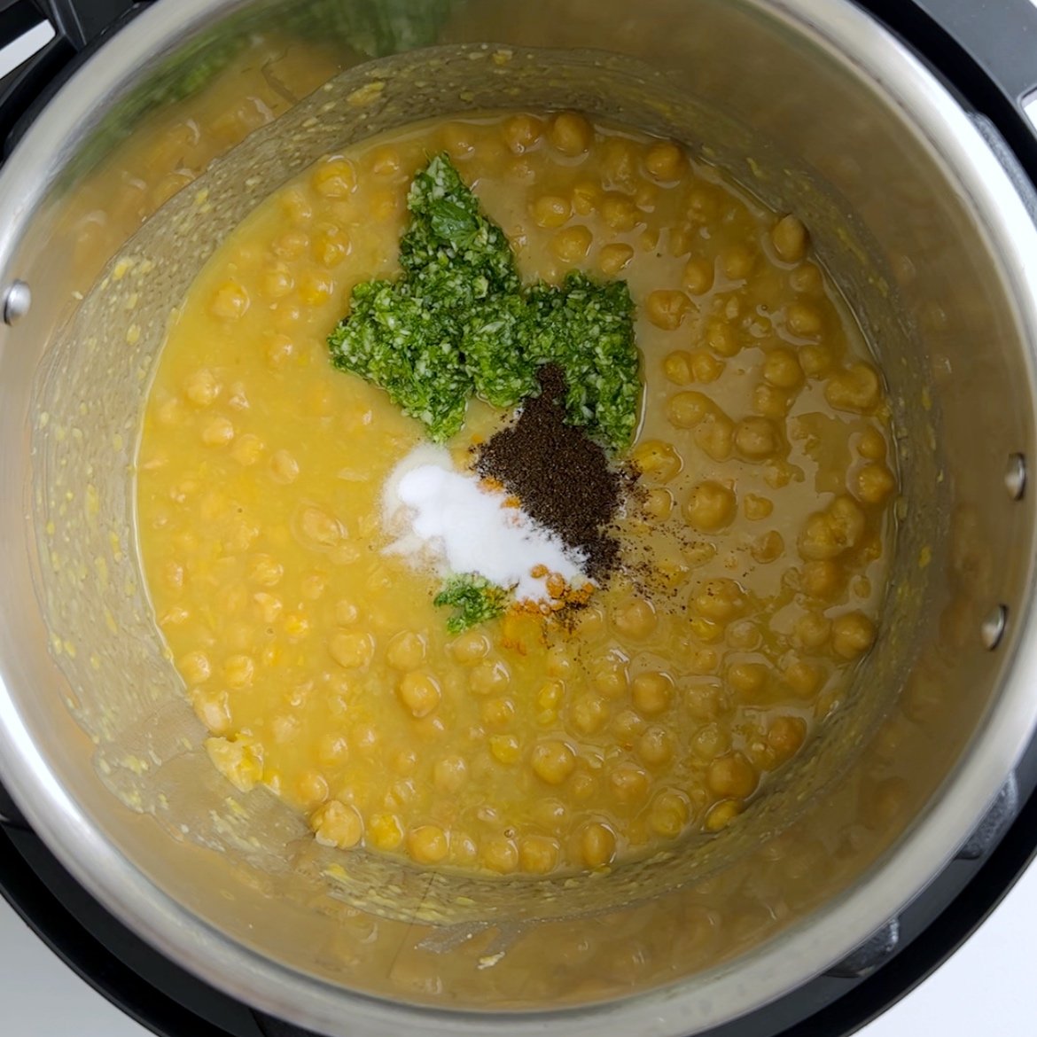 Adding seasoning to the cooked channa and dhal in the instant pot