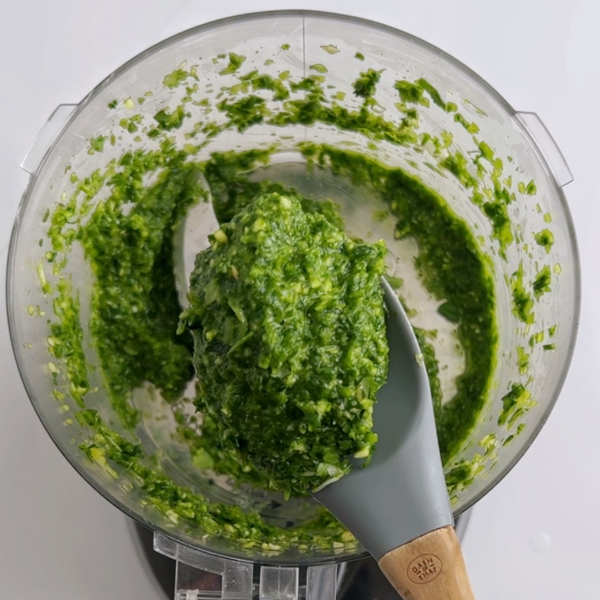 Blending aromatics and herbs in a food processor.