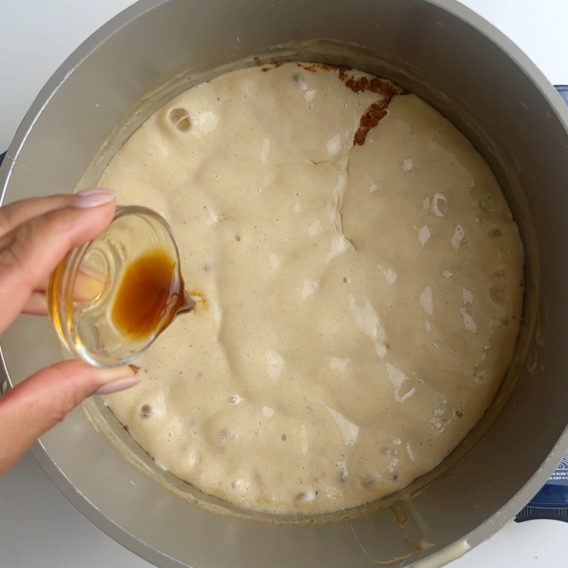 Adding vanilla to a pot of boiling flour porridge