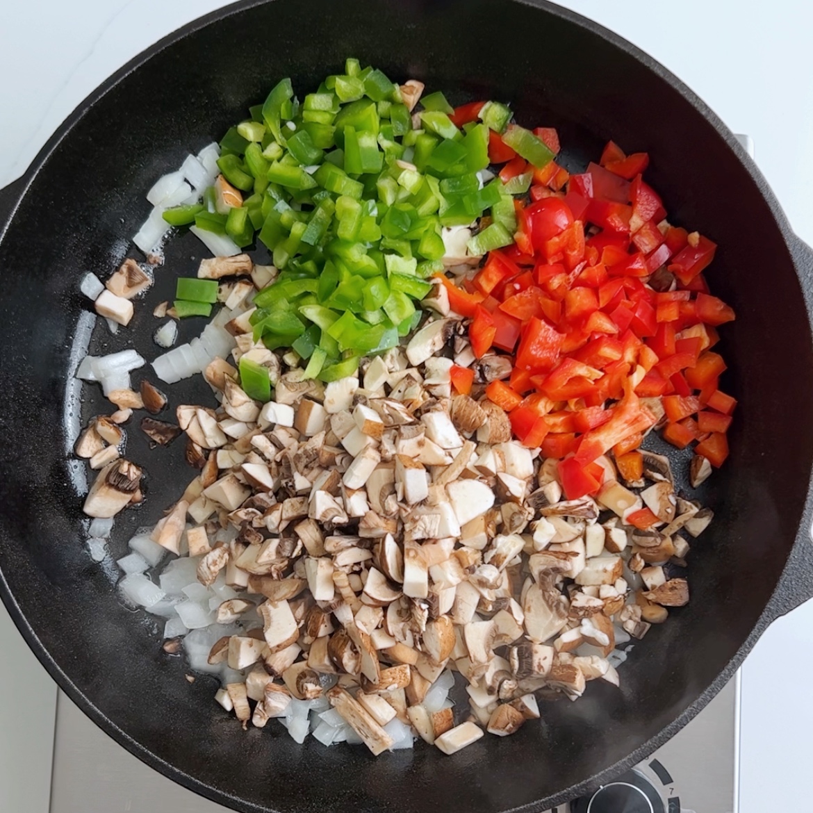 diced and sauteed peppers, onions, and mushrooms in a skillet